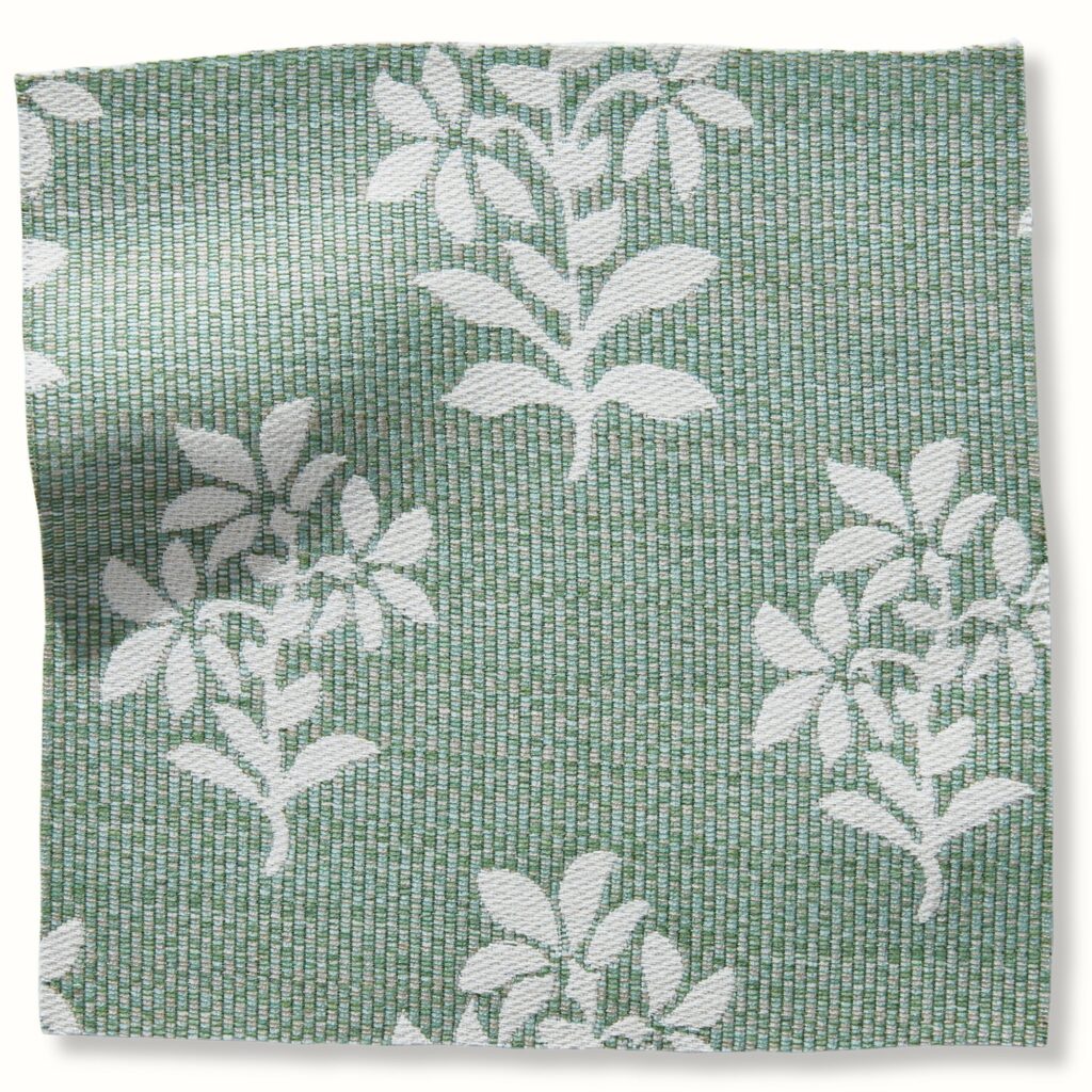 A light sage green fabric swatch with white flowers on it.