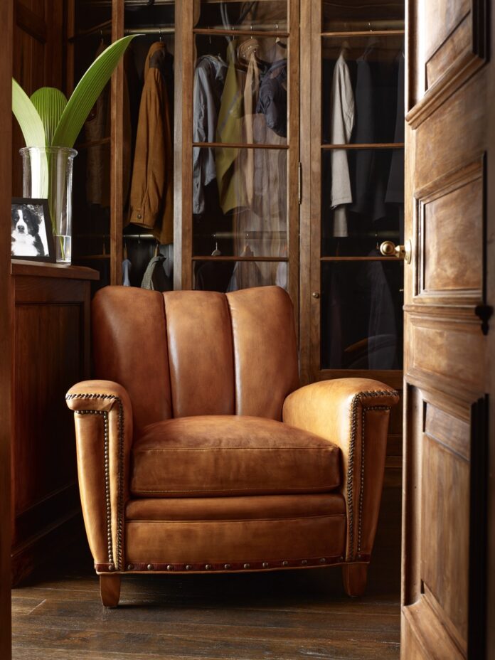Shop Local, Pittsburgh: Sewickley A brown leather chair from Sewickley business Antiquarian sits in a living room set up with light shining in from the left side.