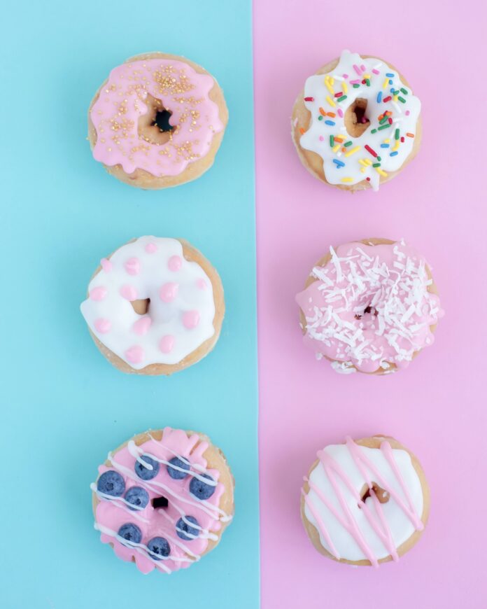 A half blue and half pink surface each with 3 donuts in a vertical row.