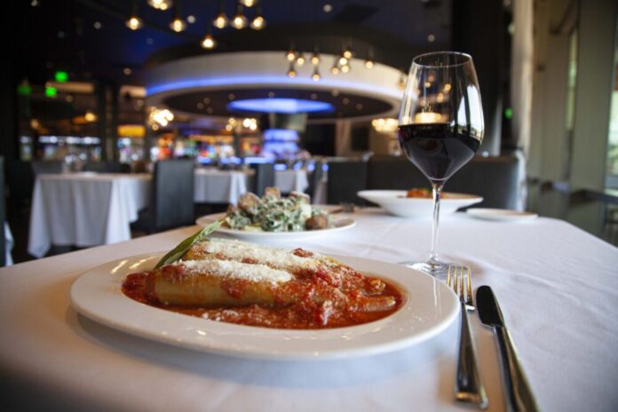 A plate of stuffed banana peppers on a white cover table in a restaurant at Rivers Casino Pittsburgh