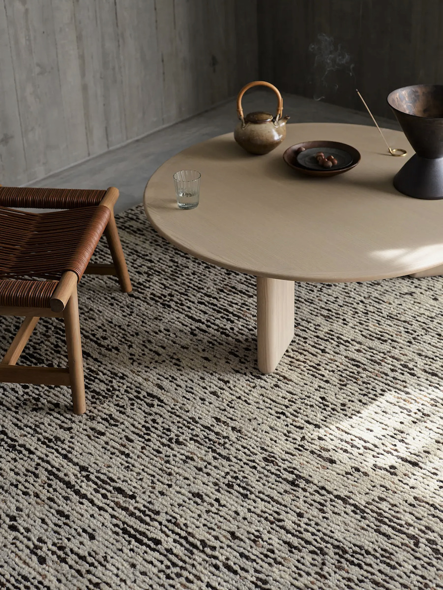 Faroe by Armadillo, a white round table on a grey rug