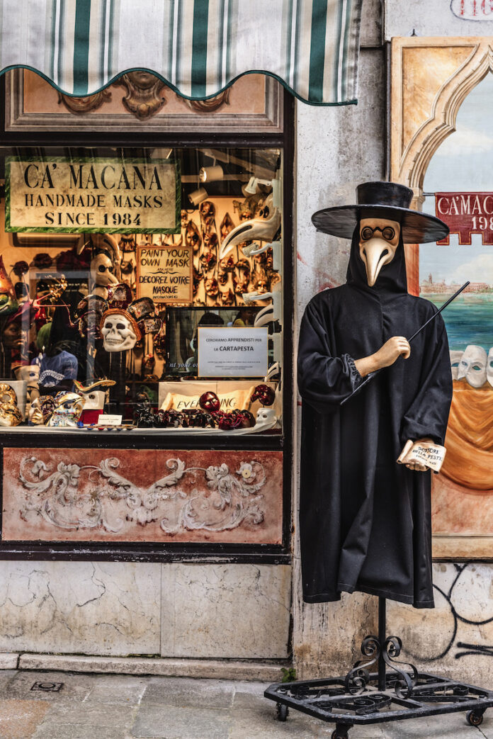 TABLE Magazine Ca' Macana Mask Shop 2 Lrg A maskamaker in Venice in a plague doctor like mask outside his shop