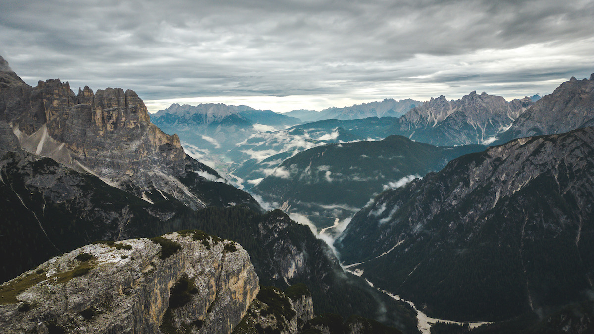 A beautiful aerial view of the Dolomites, craggy rocks and white sky 