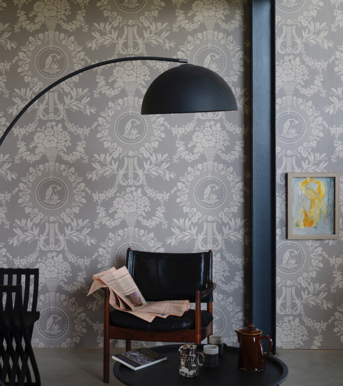 A hanging lamp over patterned grey wallpaper from Farrow & Ball