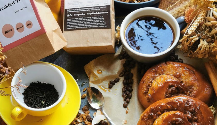 A spread of coffee, cookies, and cinnamon buns 