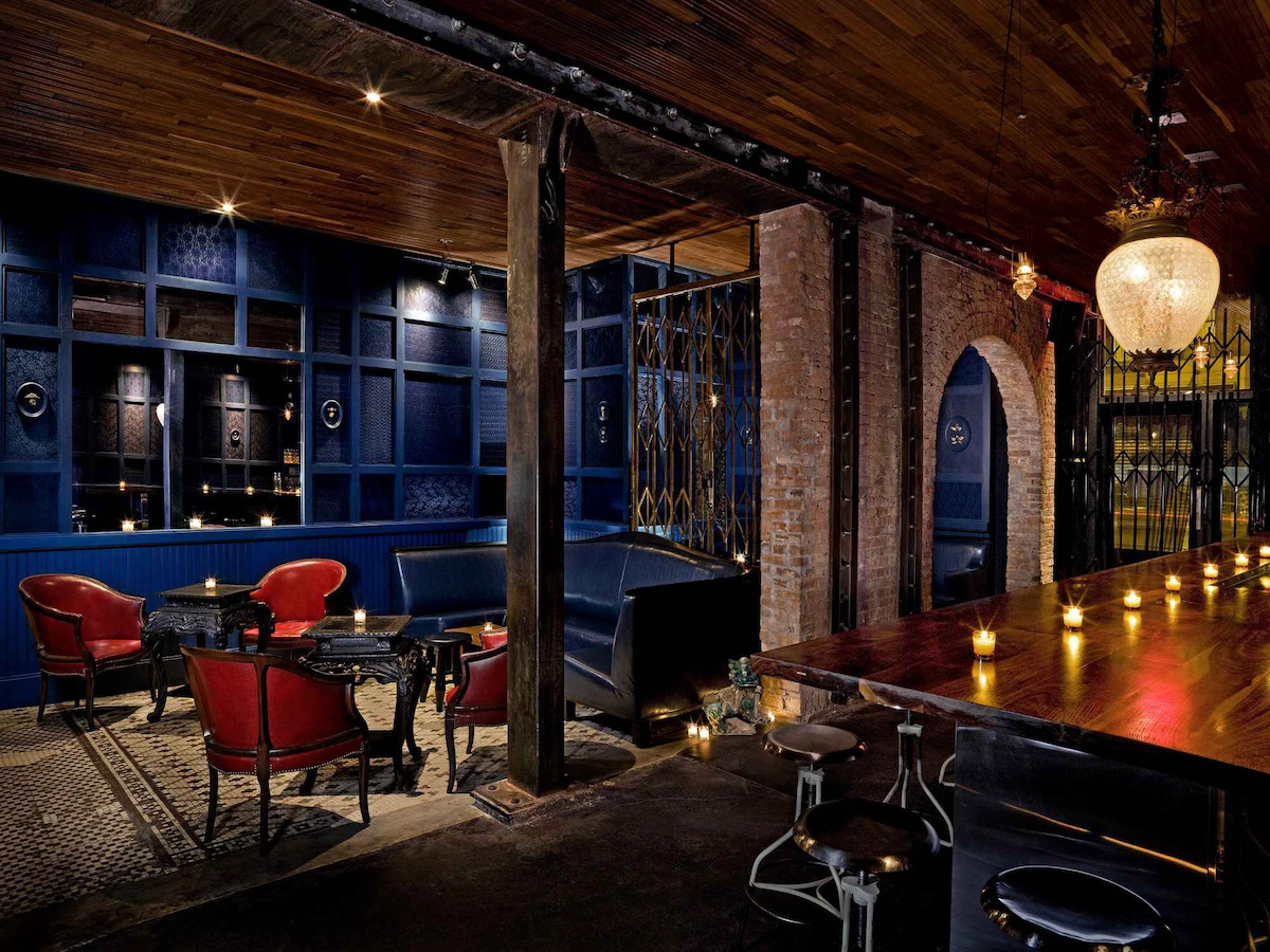 The dimly lit interior of Clover Club with arches 
