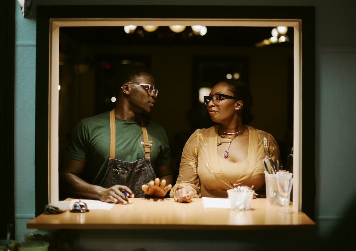 Staff at Dakar NOLA stand in front of a kitchen window