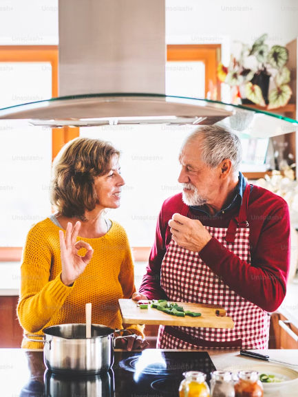 A pair of empty nesters make dinner together.