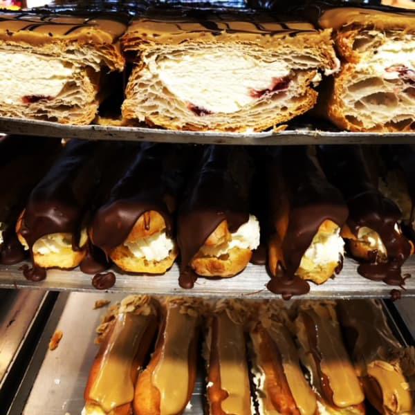 A bakery shelf with many kinds of bread on different shelves from a breakfast spot in Dublin 