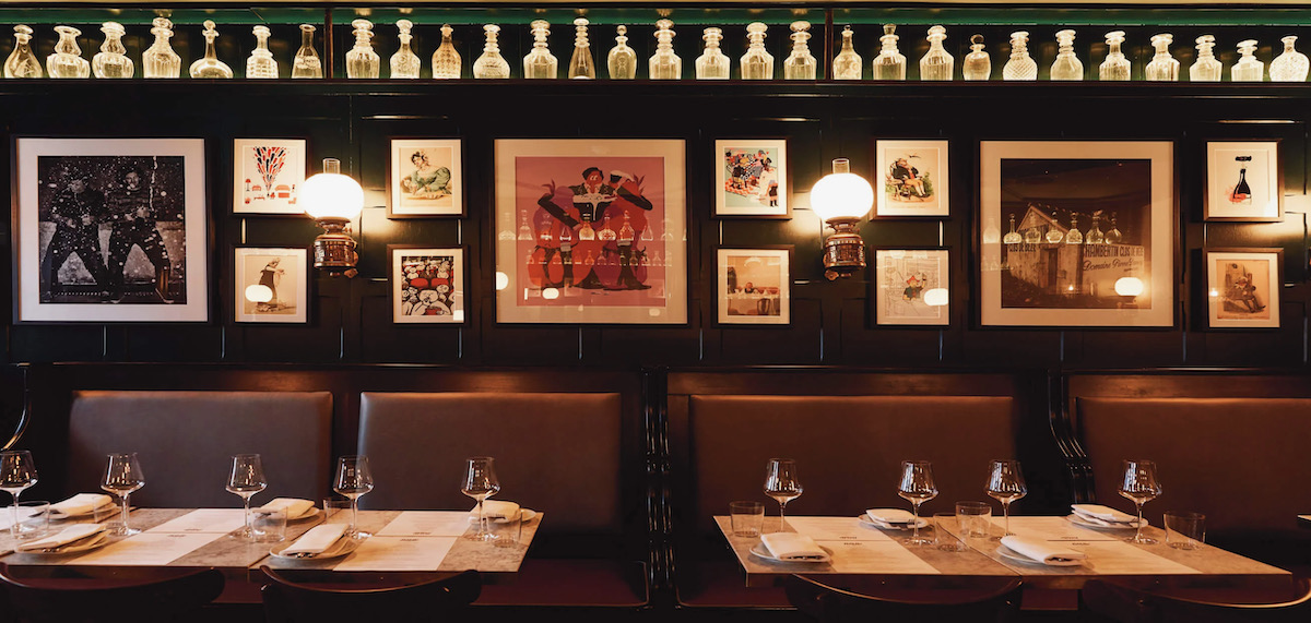 A classy wine bar, dimly lit with lots of photos on the walls 