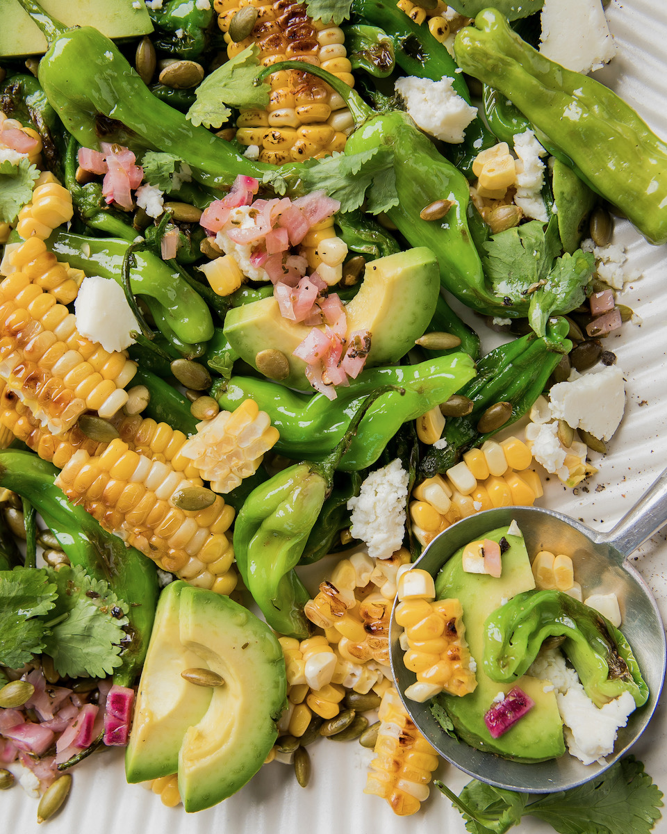 A shishito pepper corn salad in a bowl.