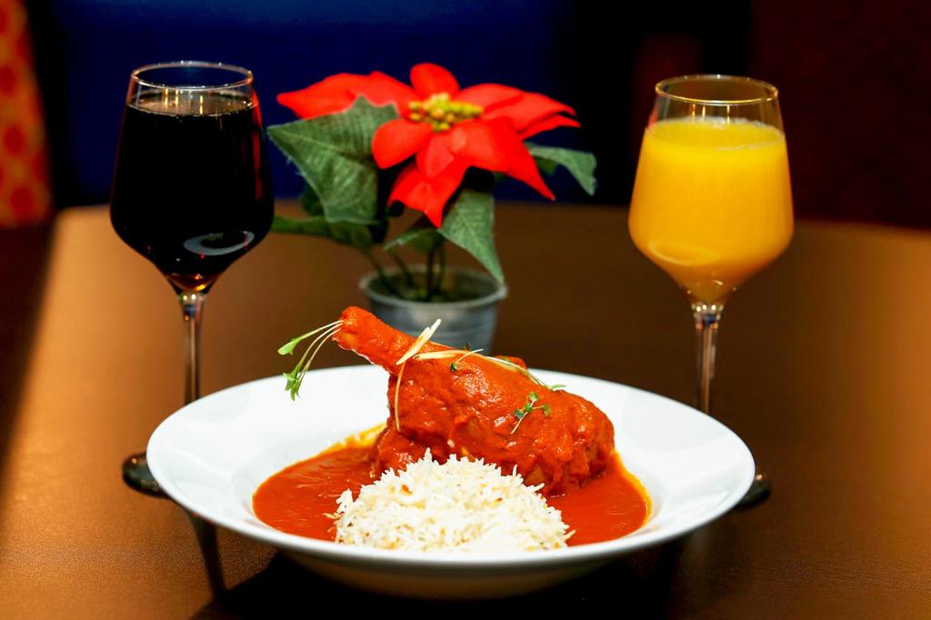 Two glasses of wine and a table setting at London restaurant Panas Gurkha 