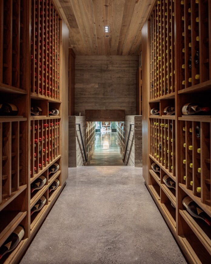 A long hallway leads you down the wine tunnel with crates of wine on both sides.