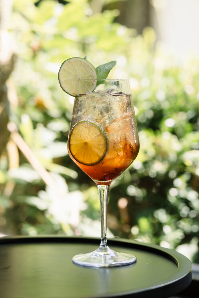 A summer spritz on a forested background on a sunny day