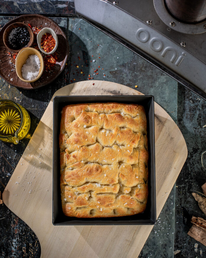 White woodfired focaccia on a teal background