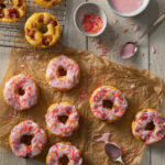 A set of peach donuts on a white background