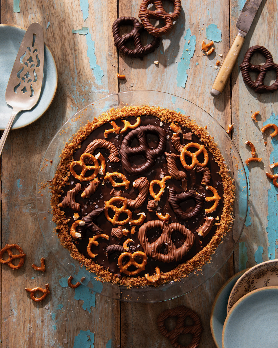A chocolate pretzel pie on a white background