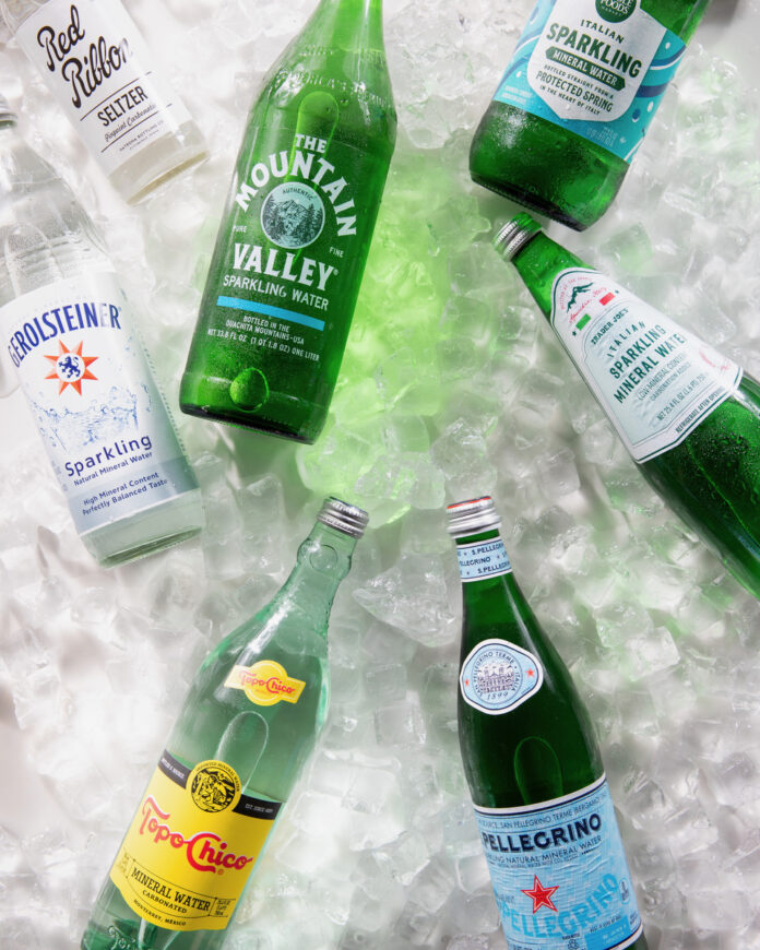 Various brands of mineral water on a bed of ice