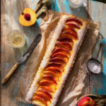 A peach bellini tart on a rustic wooden table