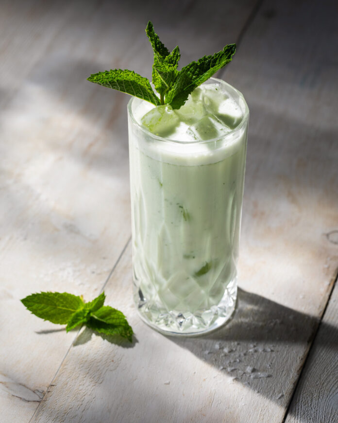 A non-alcoholic spritz with yogurt, mint, and ice in it