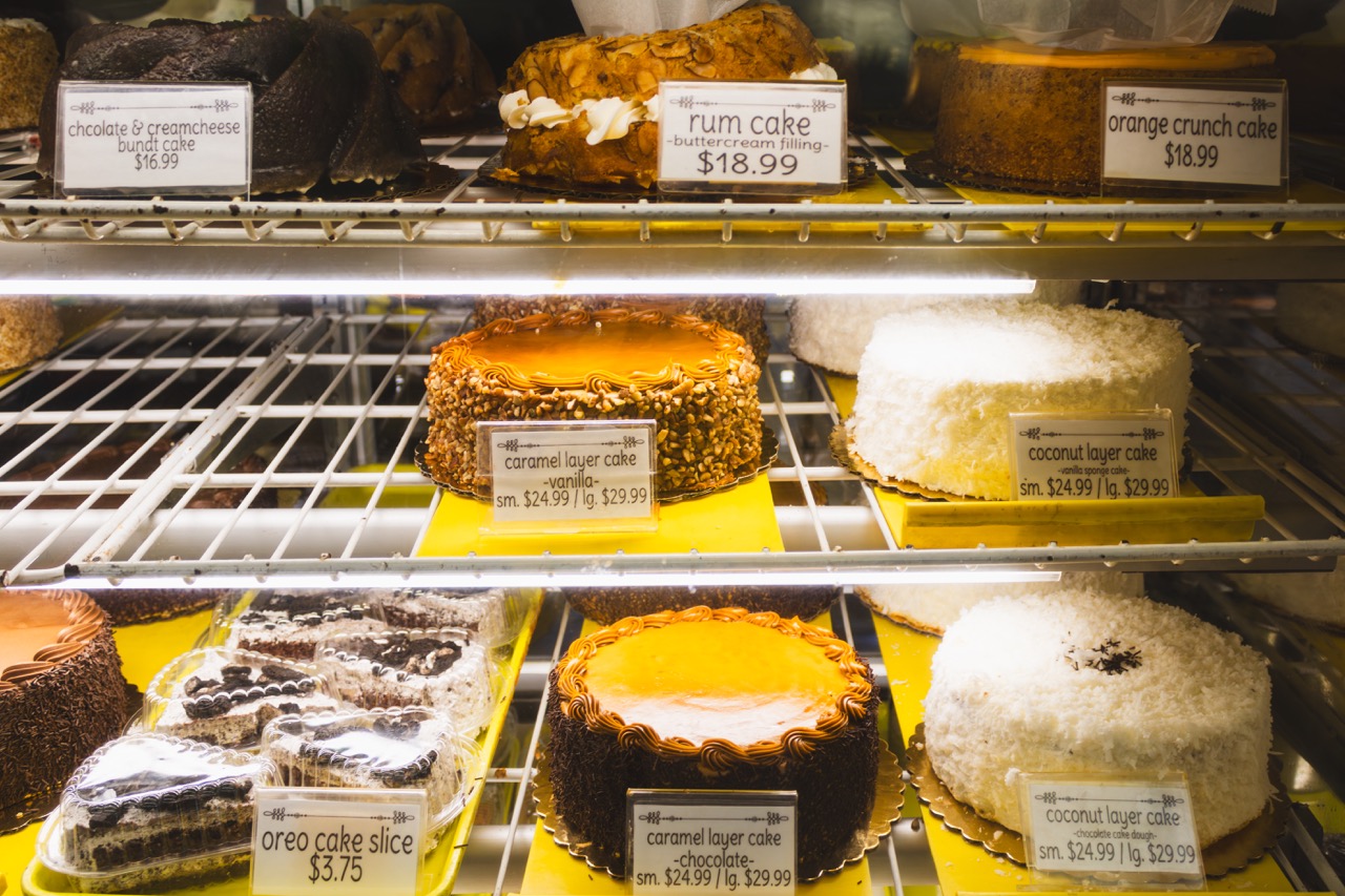 A selection of various cakes sits in a display case at Roeser's Bakery. 