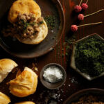 A comforting and savory dish featuring homemade flaky biscuits smothered in a rich and flavorful turkey sausage gravy, offering a hearty and satisfying breakfast or brunch option.