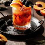 A craft bourbon smash cocktail on a black background
