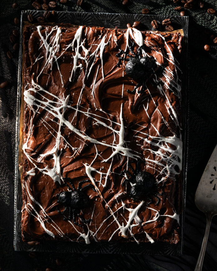 A Halloween brownie in a sheet pan drizzled to look like a spider web.
