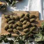 A set of goat cheese stuffed dates on a cutting board