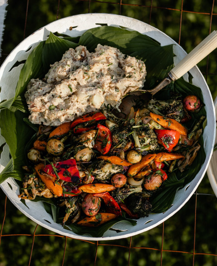 TABLE Magazine Potato Salad G Green Garlic A plate of potato salad with green garlic on a black background