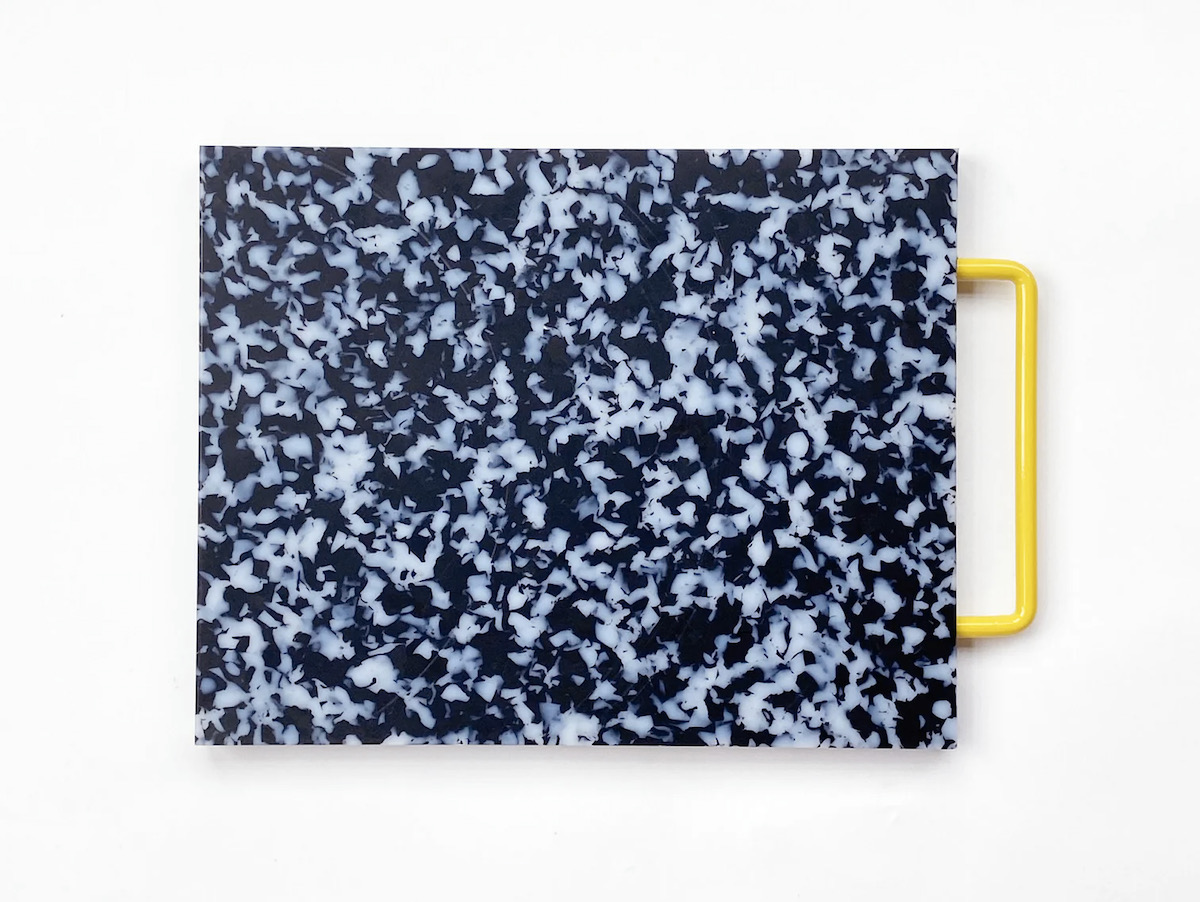 A speckled colored cutting board