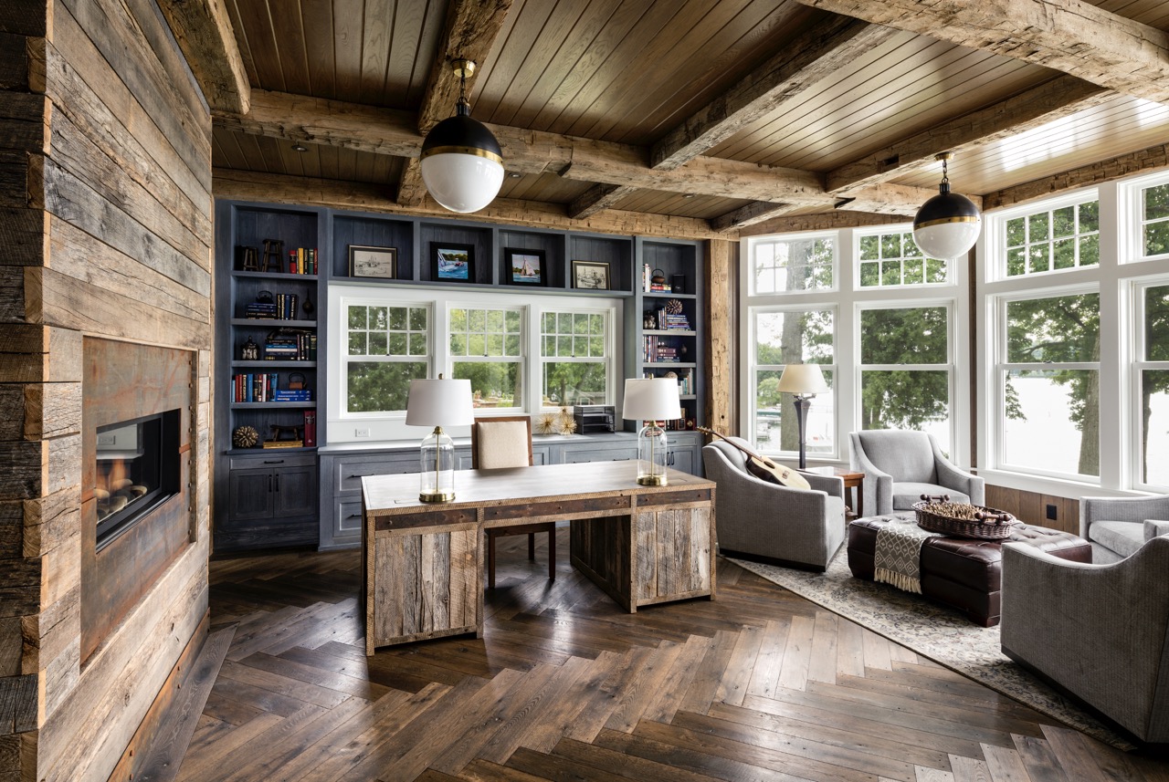 A blue cabinet sits against a wooden wall with a fireplace built into the wooden wall to the left. 