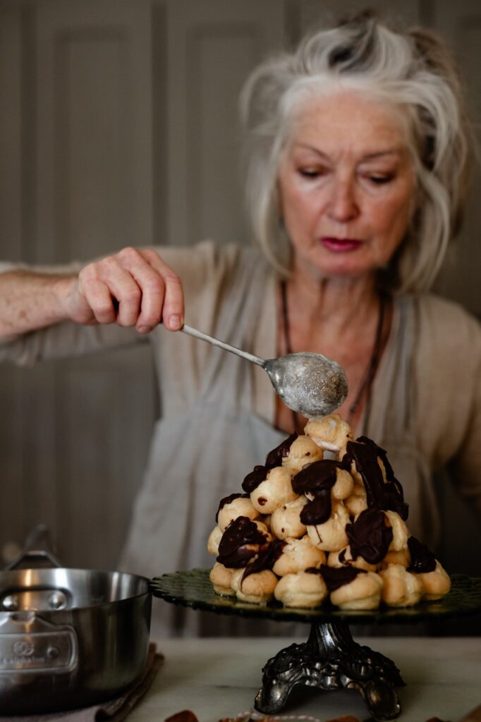 A woman drizzles glaze over a holiday dessert recipe for cake holes. 
