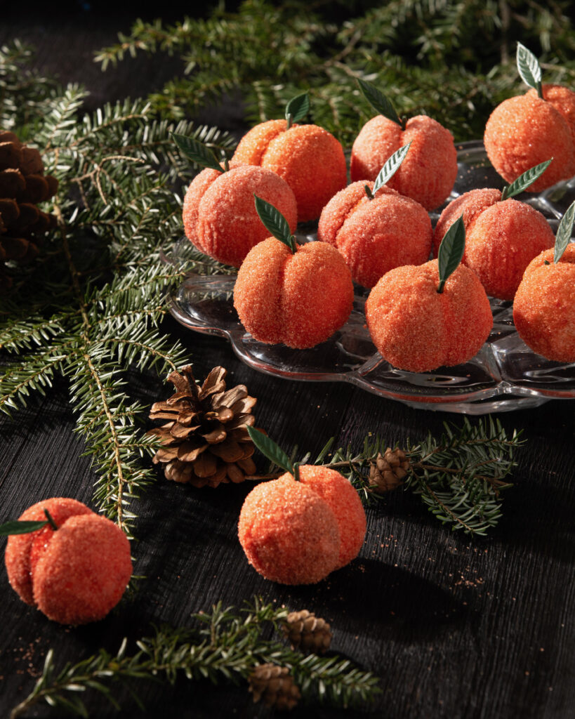 Peach cookies that look like peaches set on a Christmas background