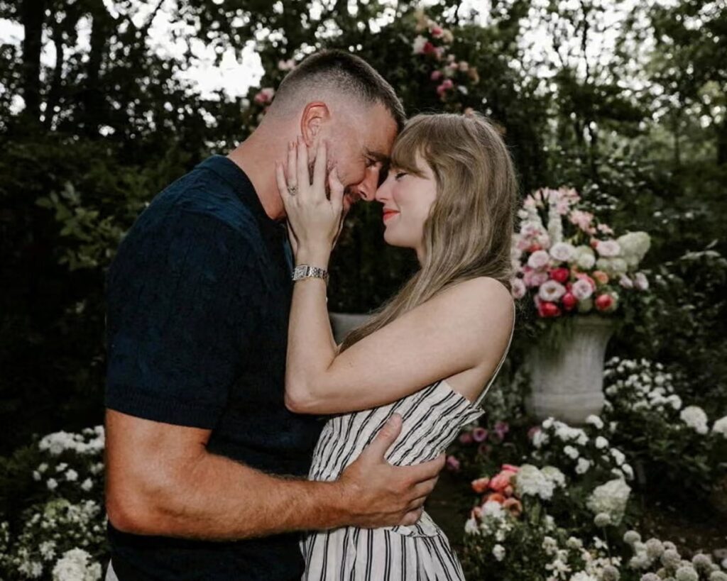 Taylor Swift and Travis Kelce with their foreheads together.