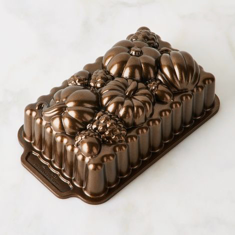 A loaf pan with pumpkins in its metal exterior