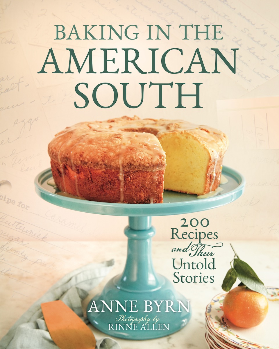The cover of the cookbook Baking in the American South, with a cake and an orange on it