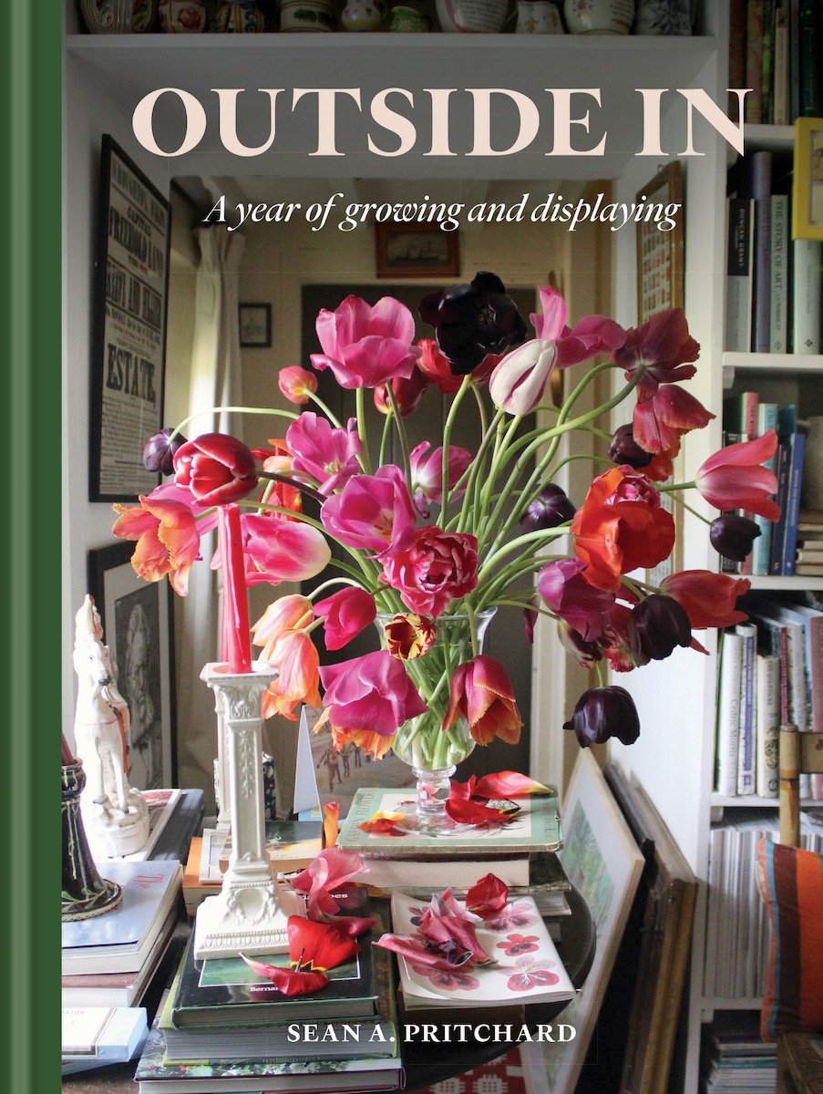 The cover of Outside In, a table setting with pink flowers 