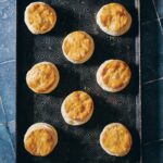 A tray of seven biscuits on a blue tile table, made by Crystal Wilkinson