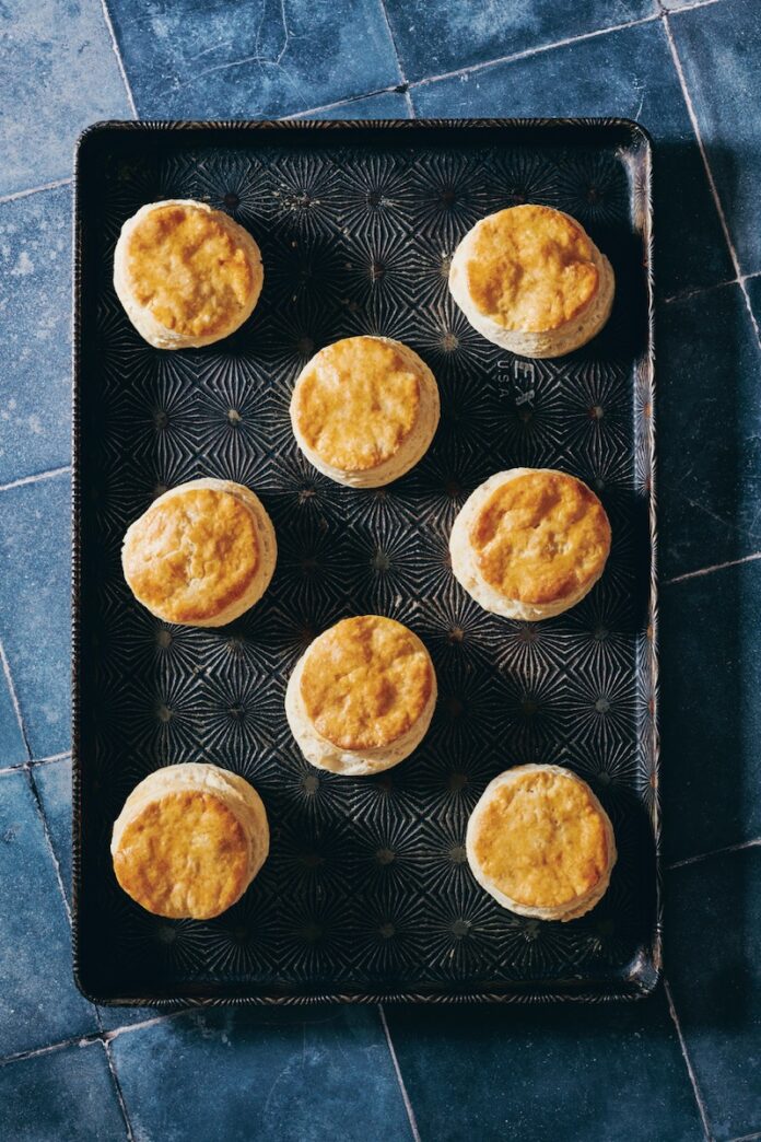 Praisesong Biscuits A tray of seven biscuits on a blue tile table, made by Crystal Wilkinson