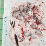 Raspberry Chocolate Truffles served in a white tray with a green wooden background