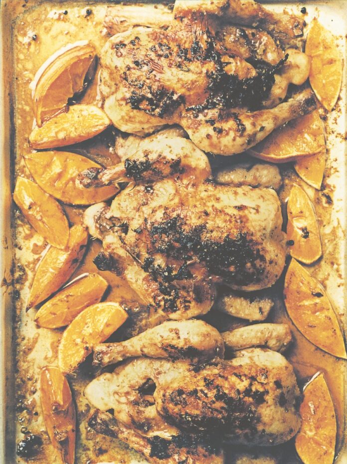 A roast of four cornish hens covered in thyme, oregano, and citrus drizzle