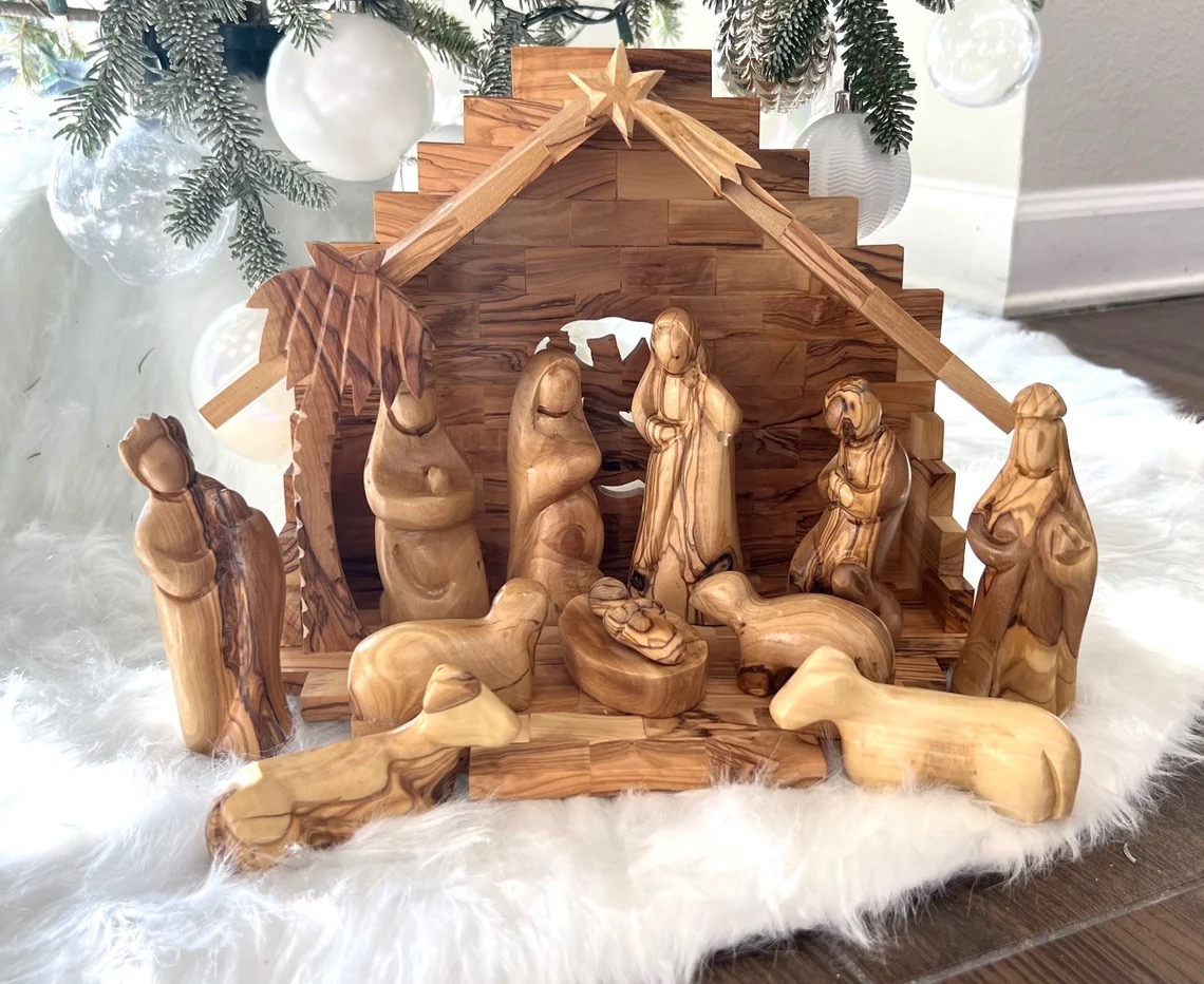 A nativity set from Etsy, staged on a snowy background