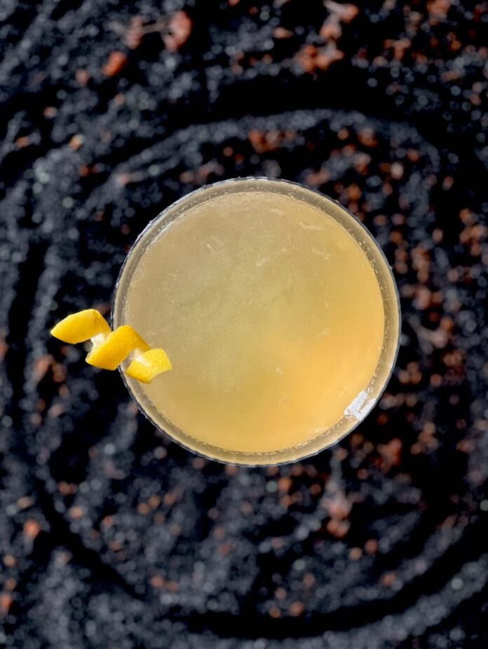 A pale yellow Paul Mescal inspired cocktail with a lemon twist