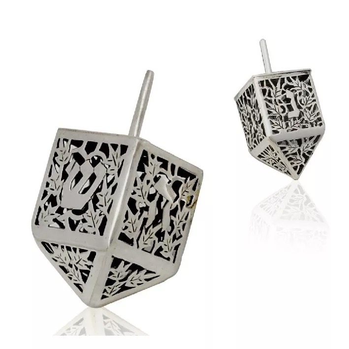 A set of silver dreidels engraved with Hebrew lettering