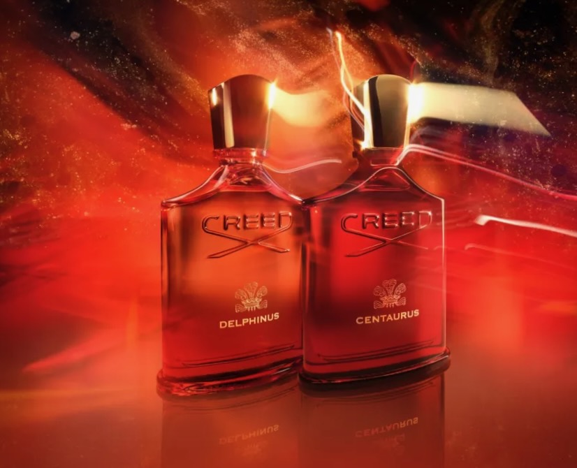 A set of Amber Universe perfumes from Creed, stage with red and orange lighting resembling a galaxy