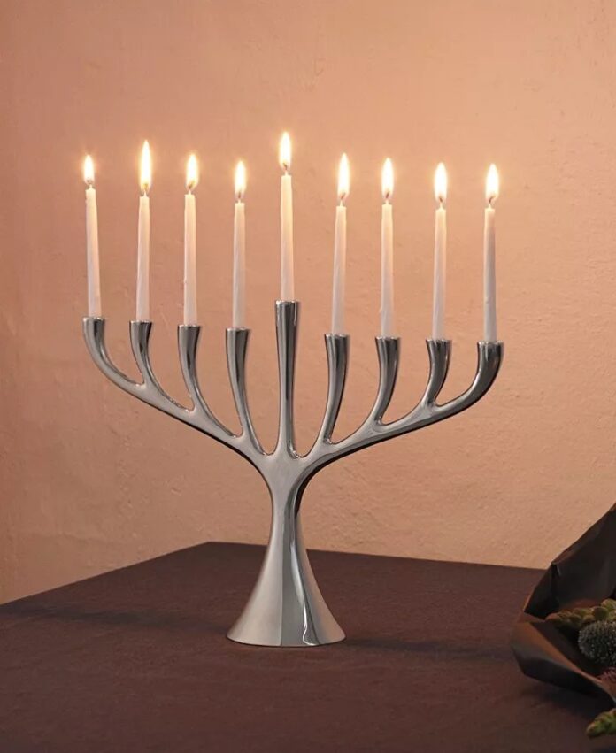 An elegant menorah from Georg Jensen. all eight candles lit