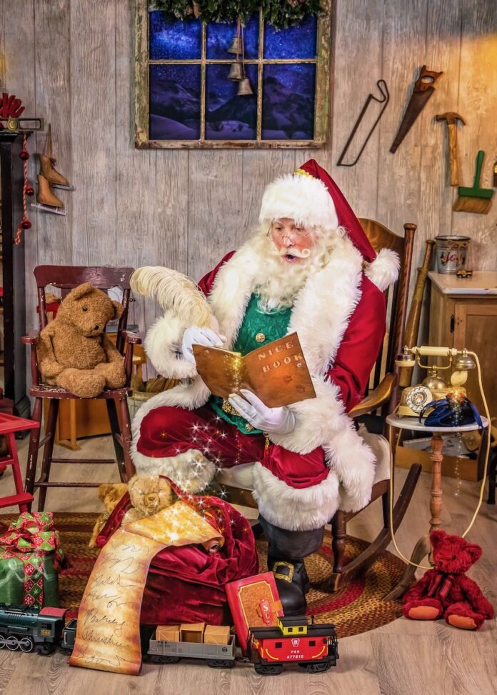9 Places in Pittsburgh to Meet Santa Claus Besides the Mall A Pittsburgh Santa Claus sits in a rocking chair with a book in his hand.