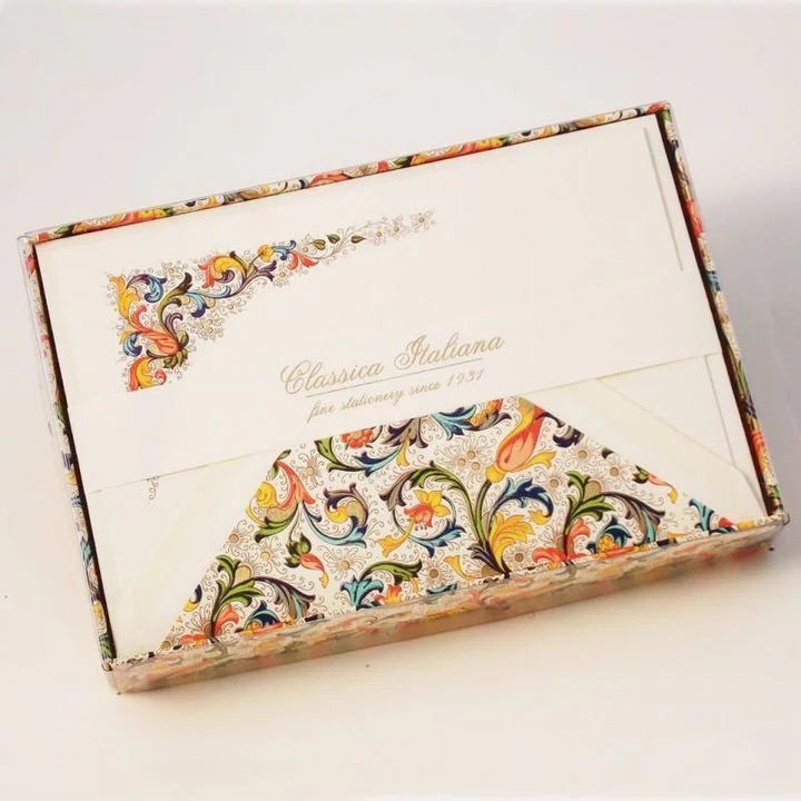 An ornate letter seal on the outside of a pale beige piece of stationery thank you card