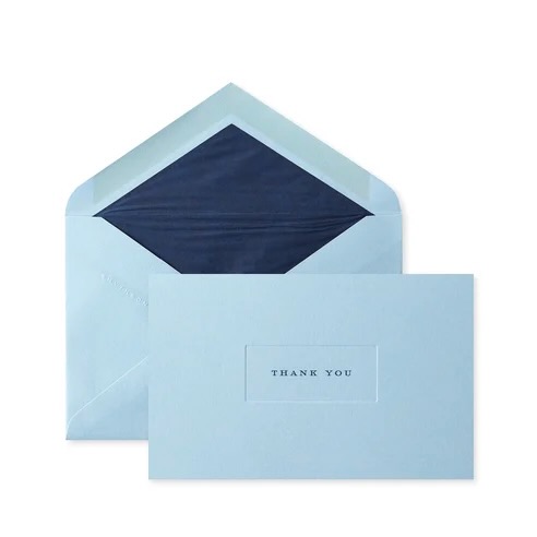 A light blue envelope from Smythson with a dark blue interior